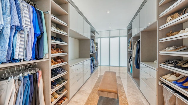 walk in closet with light tile patterned flooring