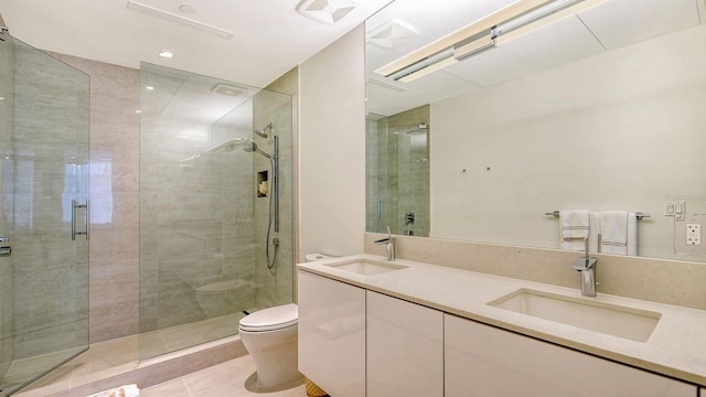 bathroom with tile patterned flooring, vanity, toilet, and an enclosed shower