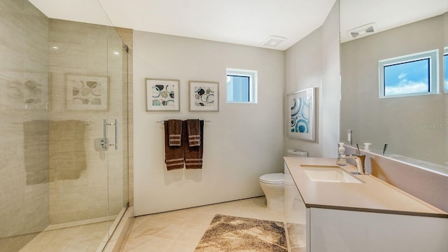 bathroom featuring toilet, vanity, tile patterned floors, and an enclosed shower