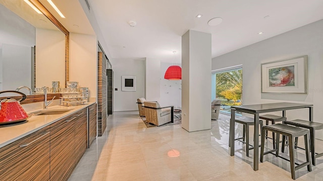 kitchen featuring light tile patterned flooring and sink