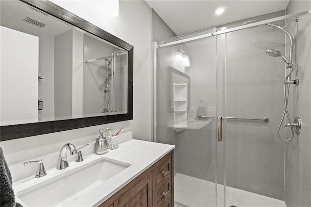 bathroom featuring vanity and a shower with shower door