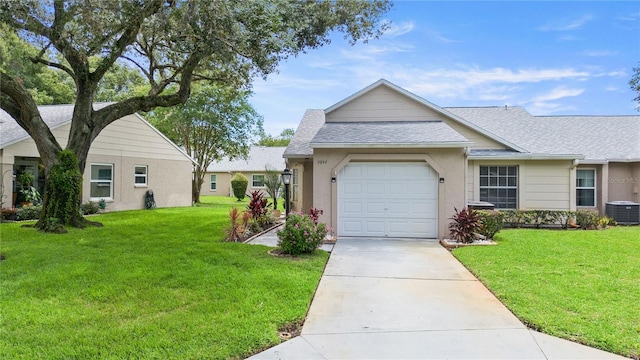 single story home with a garage, central air condition unit, and a front lawn