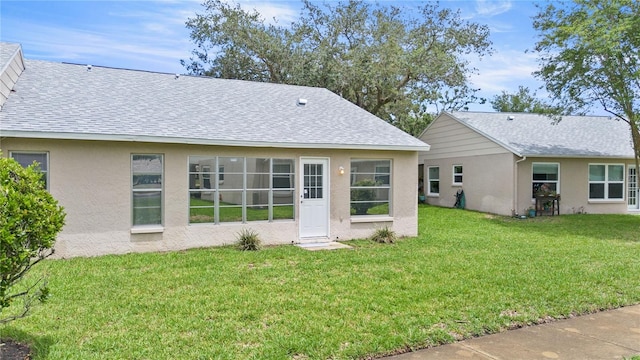 back of house featuring a lawn