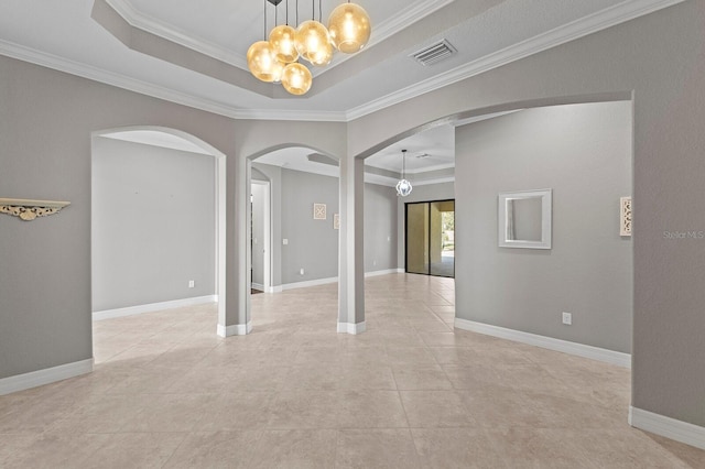 empty room with a raised ceiling, an inviting chandelier, and ornamental molding