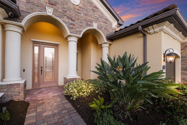 view of exterior entry at dusk