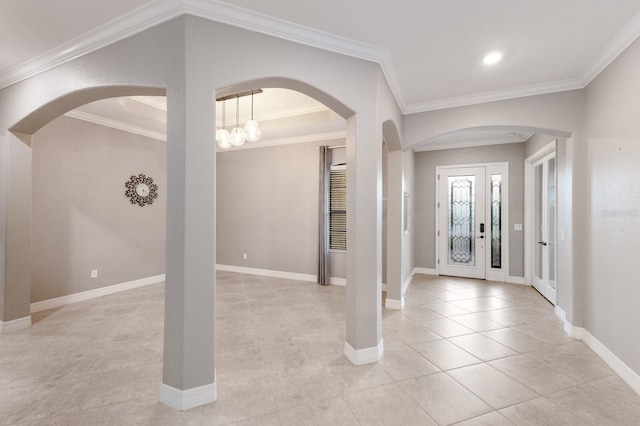 tiled entrance foyer with crown molding and a notable chandelier