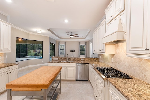 kitchen featuring black gas cooktop, white cabinets, stainless steel dishwasher, ornamental molding, and light stone counters