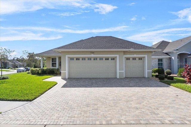 view of front of house with a garage and a front lawn