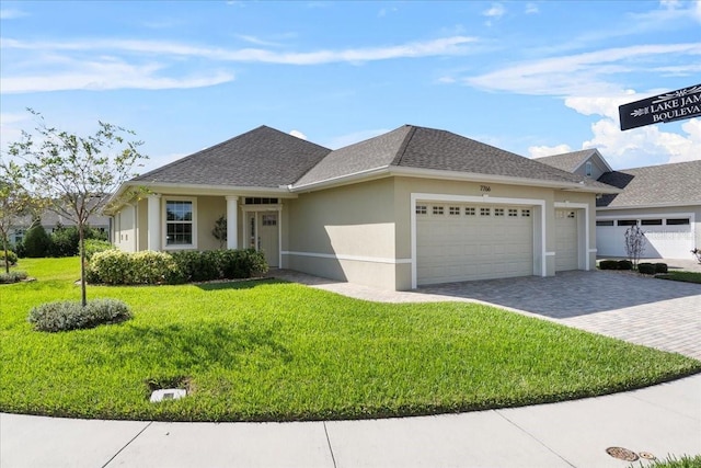 view of front of house with a front yard and a garage