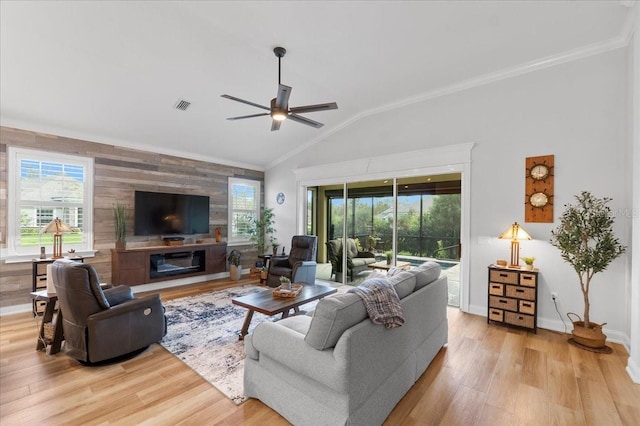 living room with ceiling fan, lofted ceiling, crown molding, and light hardwood / wood-style flooring