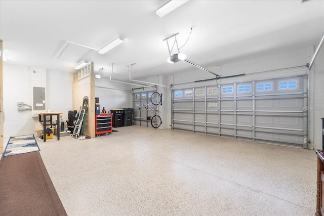 garage with electric panel and a garage door opener