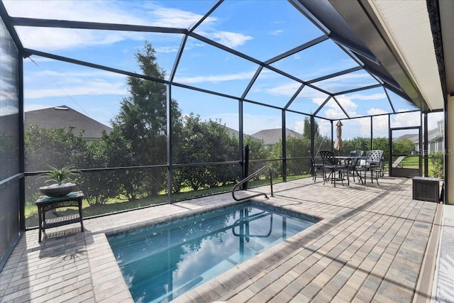 view of swimming pool featuring a patio area and a lanai