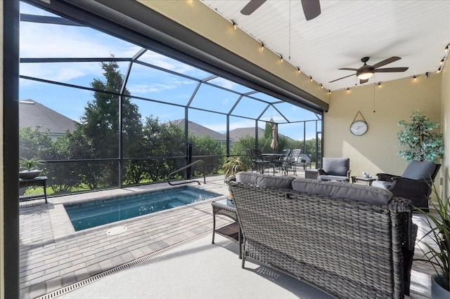 view of pool featuring a lanai, an outdoor living space, ceiling fan, a patio area, and a mountain view