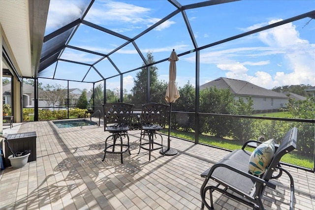 view of patio / terrace featuring a lanai