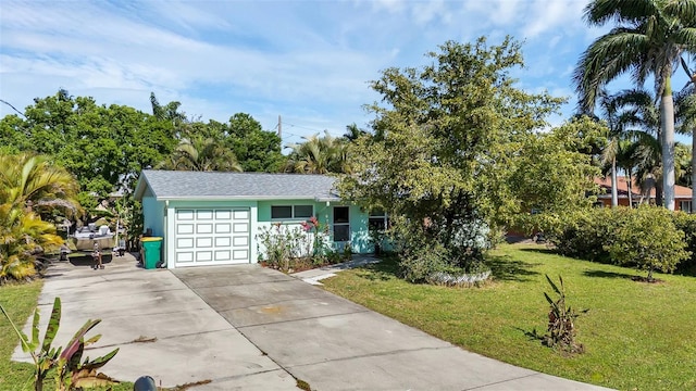 ranch-style house featuring a garage and a front lawn