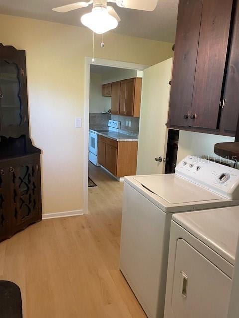 laundry room with ceiling fan, cabinets, independent washer and dryer, and light wood-type flooring