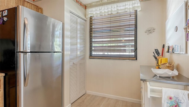 kitchen featuring light wood-type flooring and stainless steel refrigerator