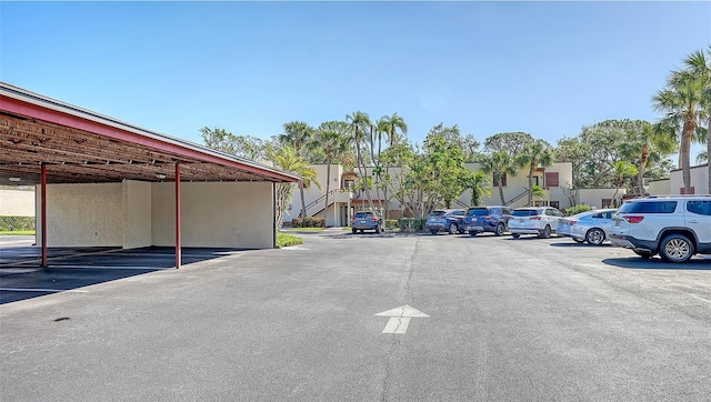 view of parking / parking lot featuring a carport