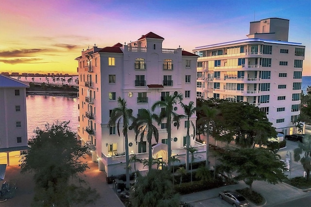 outdoor building at dusk featuring a water view