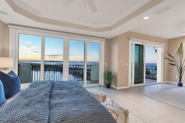 bedroom featuring access to outside, a water view, multiple windows, and ceiling fan