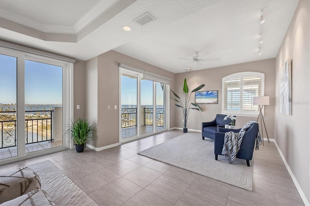 sitting room with ceiling fan, a healthy amount of sunlight, light tile patterned floors, and rail lighting