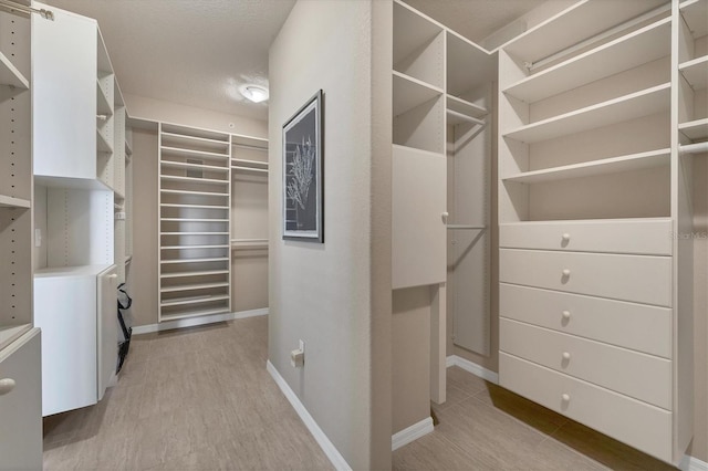 spacious closet featuring light hardwood / wood-style floors