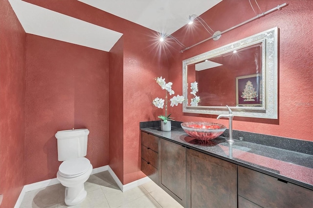 bathroom featuring tile patterned floors, vanity, and toilet