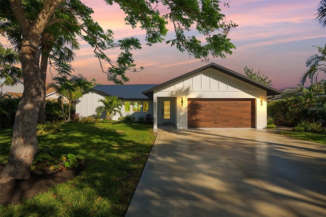 view of front of home featuring a garage and a yard