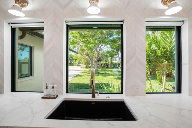 1899 Buccaneer Cir, Sarasota, FL 34231 - kitchen featuring light stone countertops and plenty of natural light