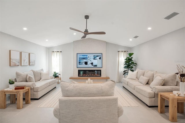 living room with a large fireplace, ceiling fan, a healthy amount of sunlight, and lofted ceiling