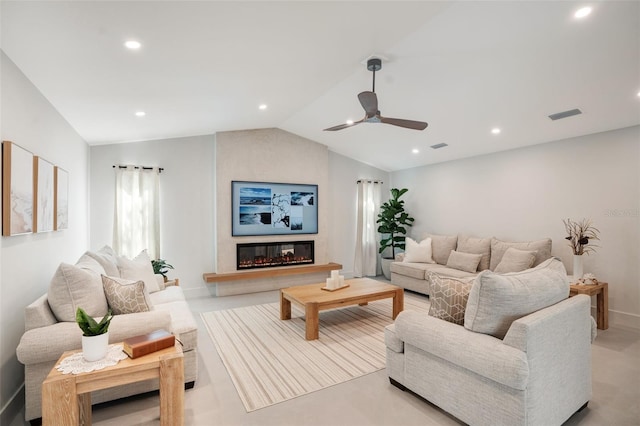 living room with a large fireplace, ceiling fan, and lofted ceiling