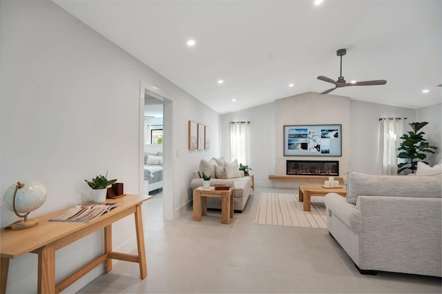 living room featuring a fireplace, vaulted ceiling, and ceiling fan