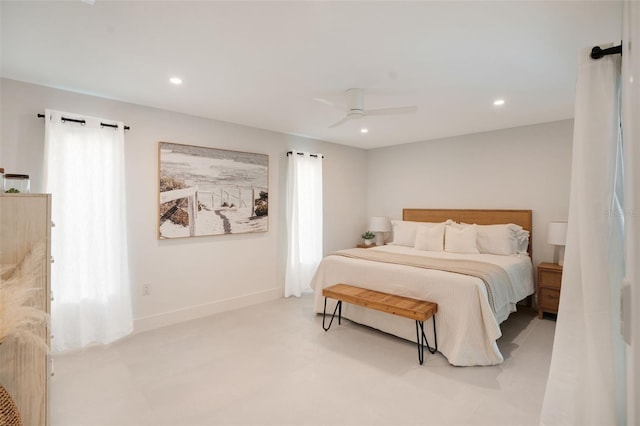 bedroom with ceiling fan and multiple windows