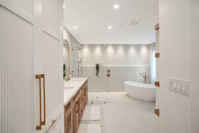 1899 Buccaneer Cir, Sarasota, FL 34231 - bathroom with a walk in shower, double vanity, a freestanding bath, tile patterned floors, and recessed lighting