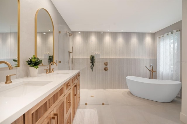 bathroom with shower with separate bathtub, vanity, and tile patterned floors