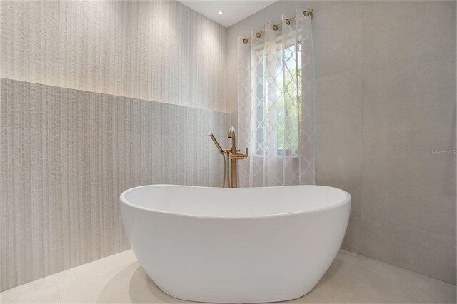 1899 Buccaneer Cir, Sarasota, FL 34231 - bathroom featuring tile walls and a freestanding tub