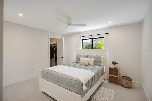 bedroom featuring a spacious closet, a closet, and ceiling fan