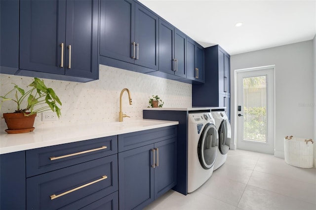 laundry room with cabinets, washing machine and dryer, sink, and light tile patterned flooring