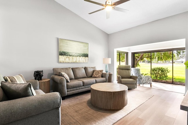 living room featuring ceiling fan, high vaulted ceiling, and light hardwood / wood-style floors