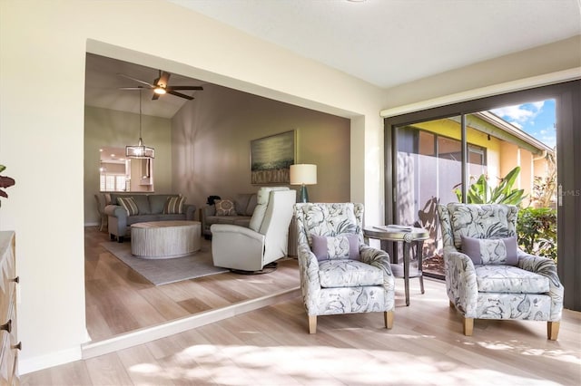 sitting room with hardwood / wood-style flooring and lofted ceiling