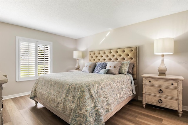 bedroom with dark hardwood / wood-style floors