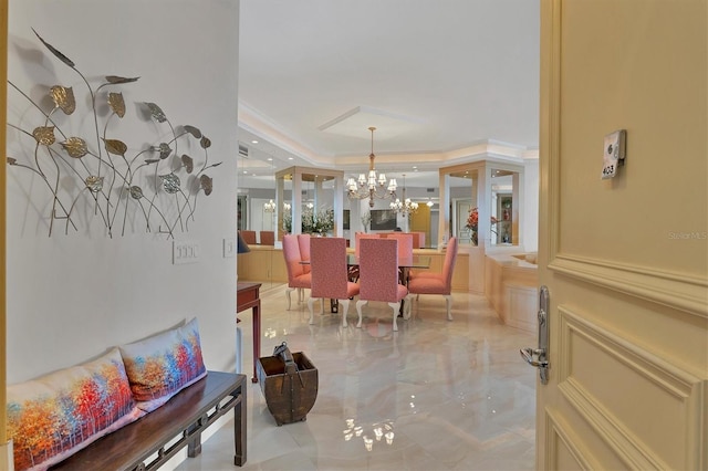 dining area featuring crown molding and a chandelier