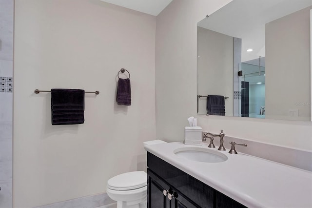 bathroom featuring toilet, an enclosed shower, and vanity