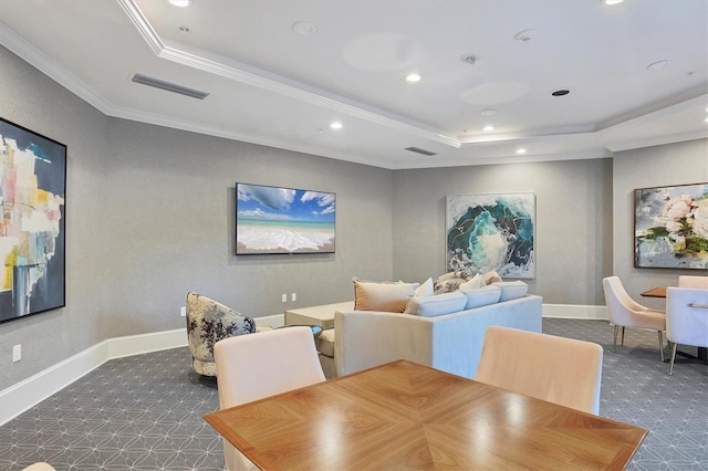 carpeted dining room featuring a tray ceiling and crown molding