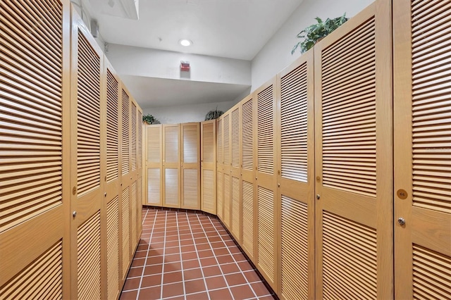 corridor featuring dark tile patterned flooring