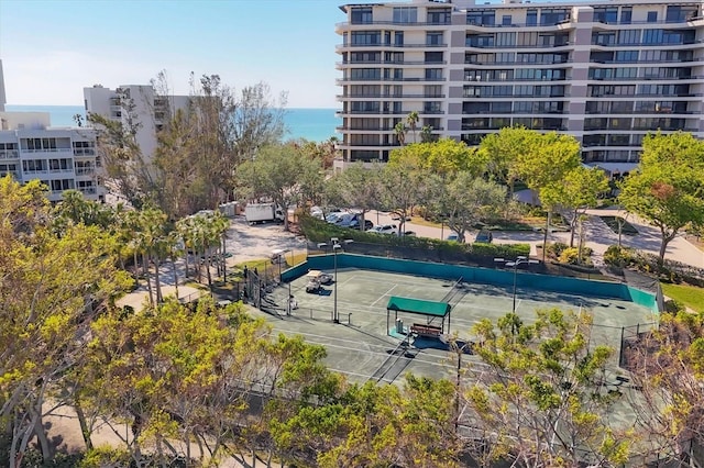 view of property's community with a water view and tennis court