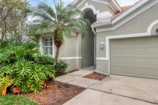 view of exterior entry with a garage