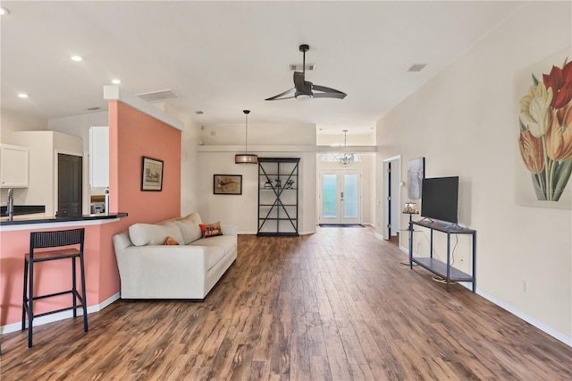 living room featuring dark hardwood / wood-style floors, ceiling fan, sink, and french doors