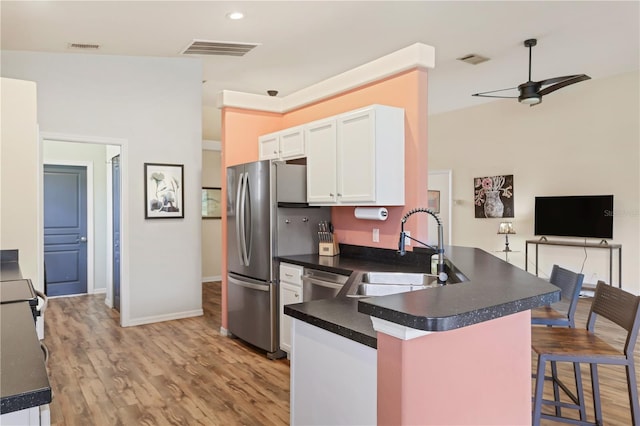 kitchen with kitchen peninsula, ceiling fan, sink, light hardwood / wood-style flooring, and white cabinets