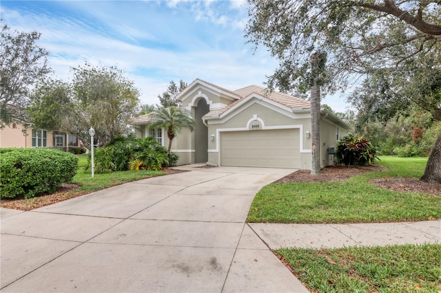 view of front of home with a front lawn and a garage